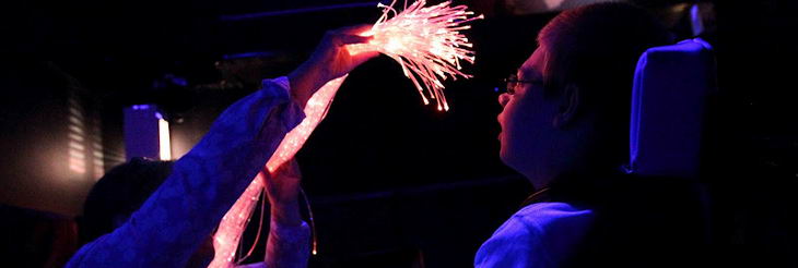 A teenage boy uses a sensory room