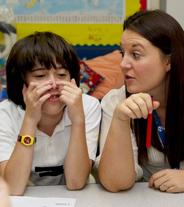 Boy and teacher as desk