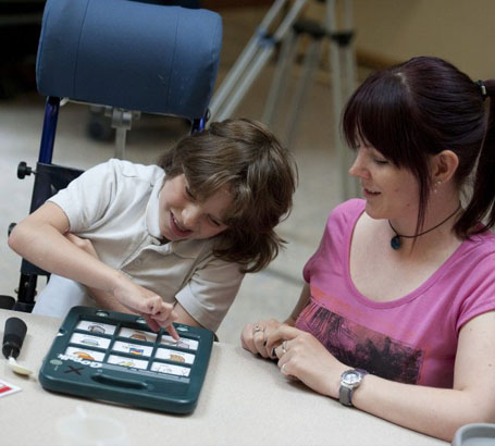 A boy uses a communication device