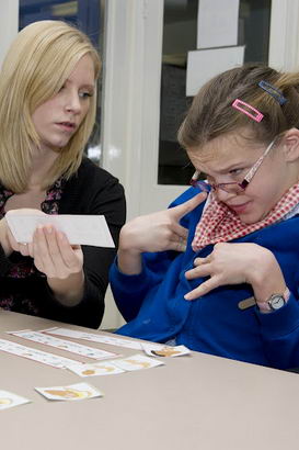A girl and her teacher work through
a sequence of instructions