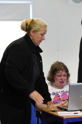 Two adults help to calm a distressed girl