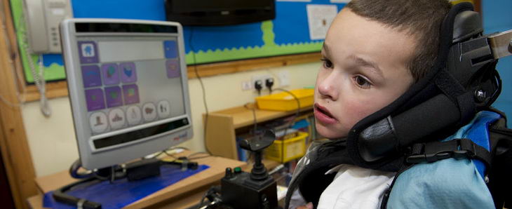 A boy uses some ICT equipment