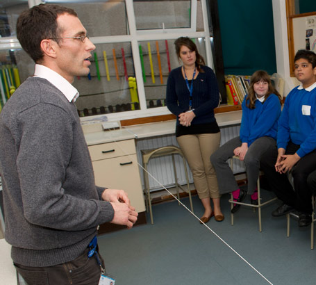 Several children and two teachers
                  in a science class