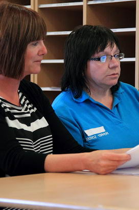 Two teachers in front of a computer