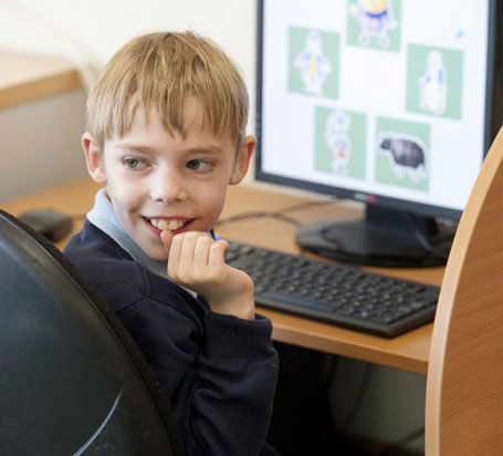 Young boy in stripy top with hands behind
                  head displays relaxed body language