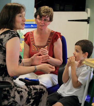 A boy with two teachers