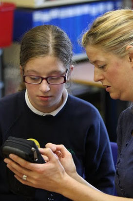 Teacher communicates with teenage girl
through handheld