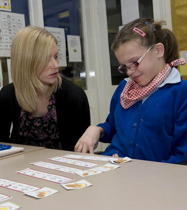 a female pupil and teacher learn
                  side by side using various personalised techniques in a classroom
