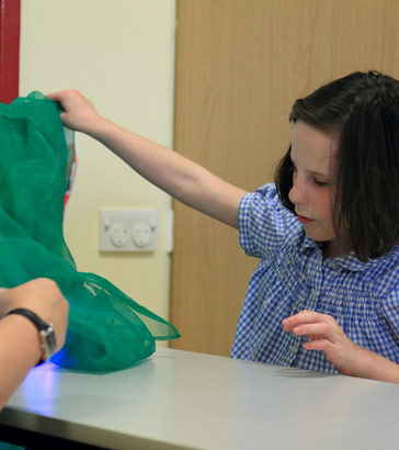 teacher testing girl’s ability to
                  find things at desk