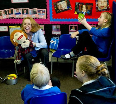 Teacher with puppet in class