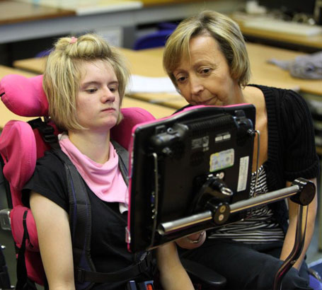 A girl in a wheelchair with her teacher