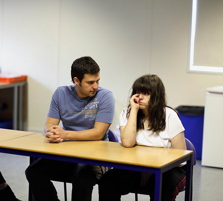 Male carer at desk with teenage girl