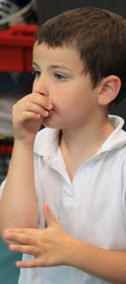 An anxious child holds his head in his
hands