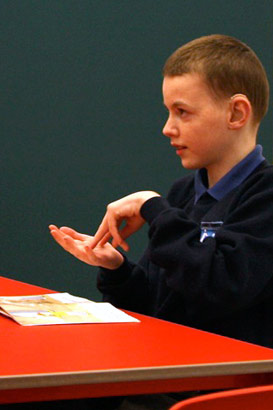 A teacher comforts a young boy who is
distressed