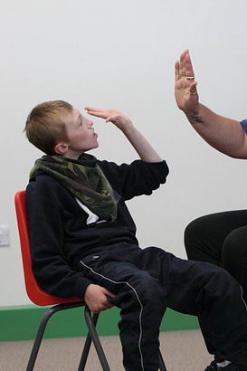 A boy participates in an intensive interaction
session