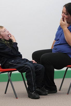 A boy participates in an intensive interaction
                  session