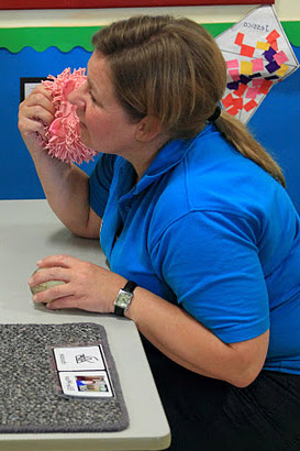 a young girl interacts with her carer
whilst sat opposite each other