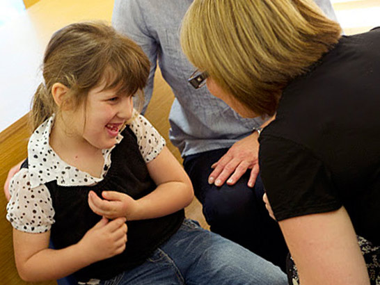 Girl laughing with teachers