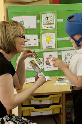 A boy and his teacher interact