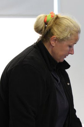 Two teachers comfort a distressed pupil
who is using a laptop