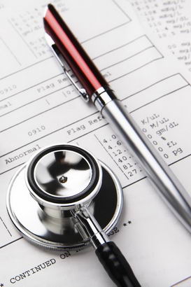 A stethoscope, pen and diagnostic
document