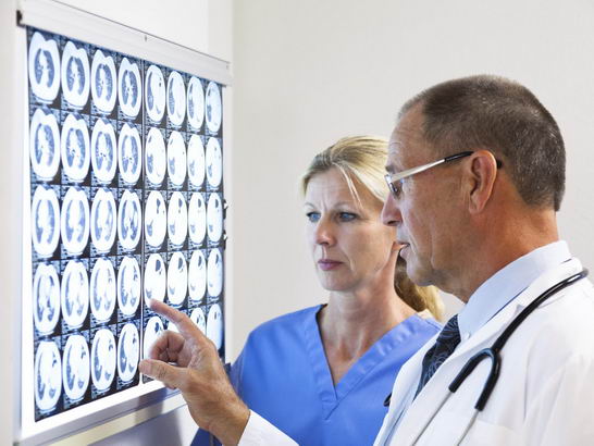 Clinicians examine an xray
                  in the search for a diagnosis