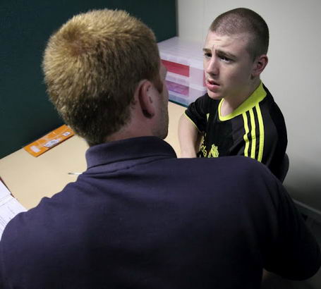 A teenage boy speaks with his teacher
during a diagnostic review
