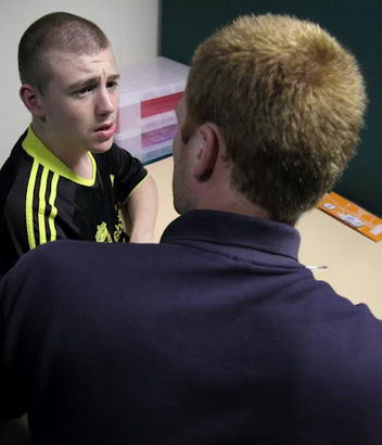 A teenage boy speaks with his teacher
during a diagnostic review