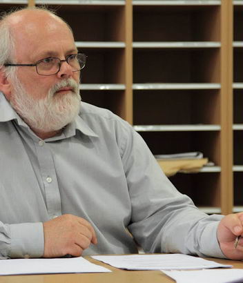 A male teacher at his desk