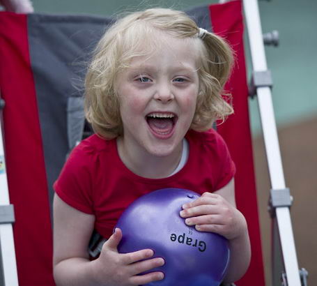 Girl in playground with ball