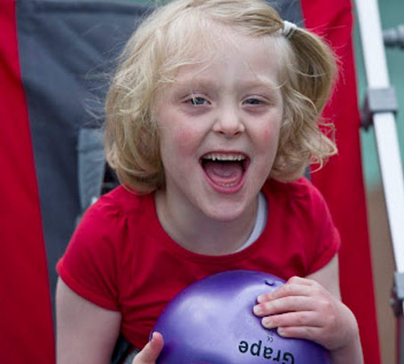 Girl in playground with ball