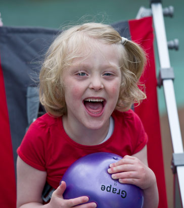 Girl in playground with ball