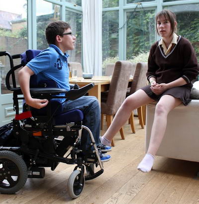 A boy in a wheelchair and his sister