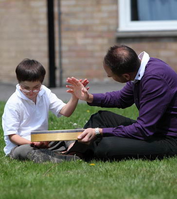 A boy and his teacher with a drum