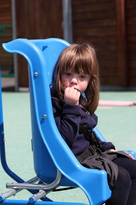 A girl sits in a playground