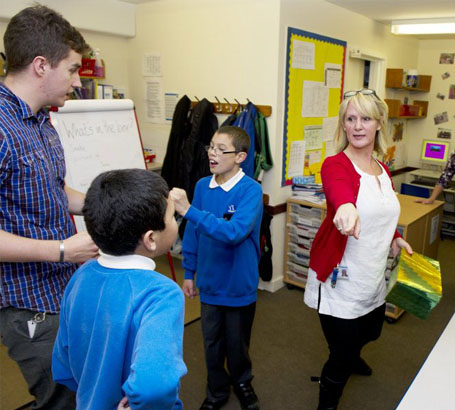 Using a toy two teachers interact with
                  a child