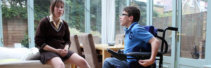 A boy in a wheelchair and his sister