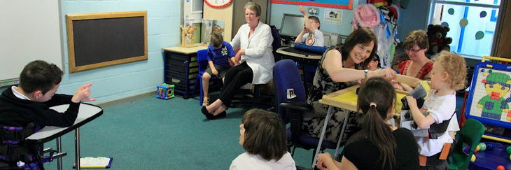 Several children and teachers in a classroom