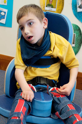 A boy sitting with leg splints