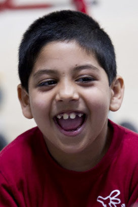 Laughing boy in a chair