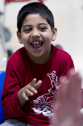 Laughing boy in a chair