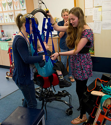 A boy being lifted in a hoist