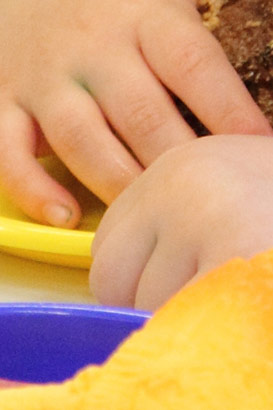 A boy with a tray of items looks at the
                  camera