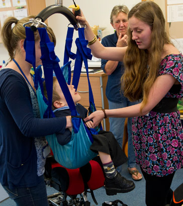 A boy being lifted in a hoist