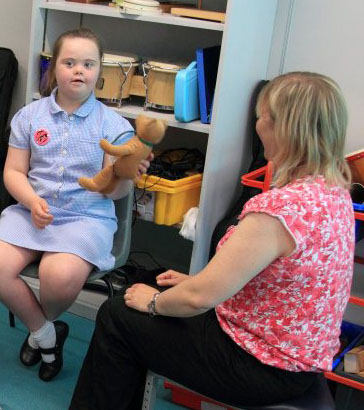 a teacher holding a young child