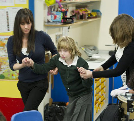 Two teachers at a computer talking 