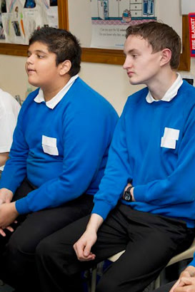 Two boys listening.