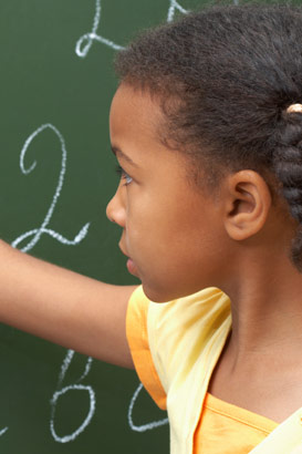 Girl doing calculations
                  on a board.