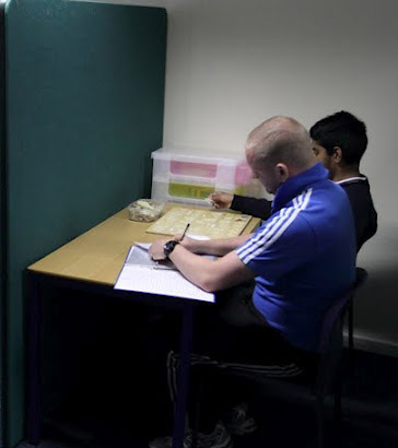 Teacher helping a boy write