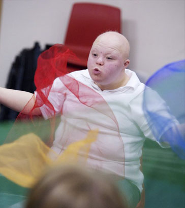 Boy throwing a net in front of
                  his face